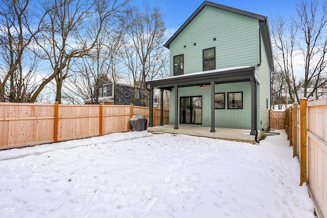 snow covered property with ceiling fan