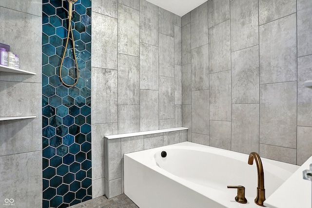 bathroom featuring tile walls and a tub