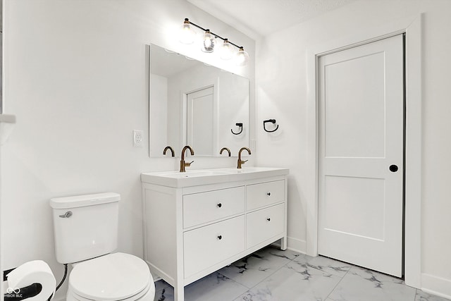 bathroom with toilet, a textured ceiling, and vanity