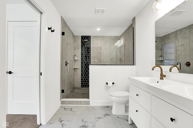 bathroom featuring a tile shower, vanity, and toilet