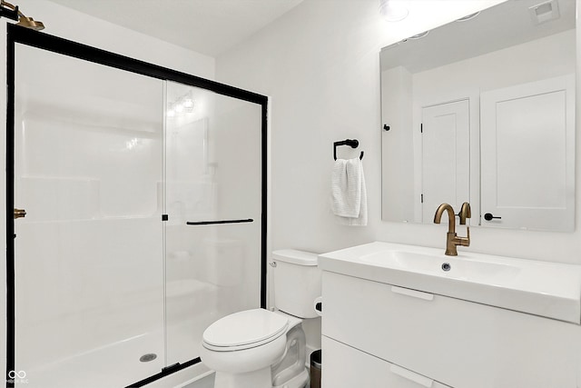 bathroom with toilet, a shower with door, and vanity