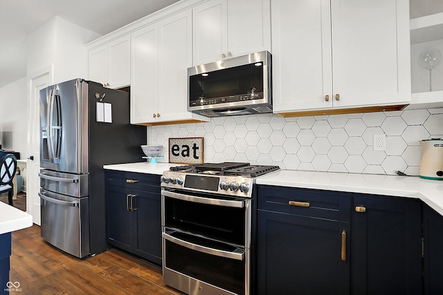 kitchen featuring stainless steel appliances, dark hardwood / wood-style flooring, white cabinets, and decorative backsplash