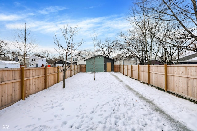 yard covered in snow with a storage unit