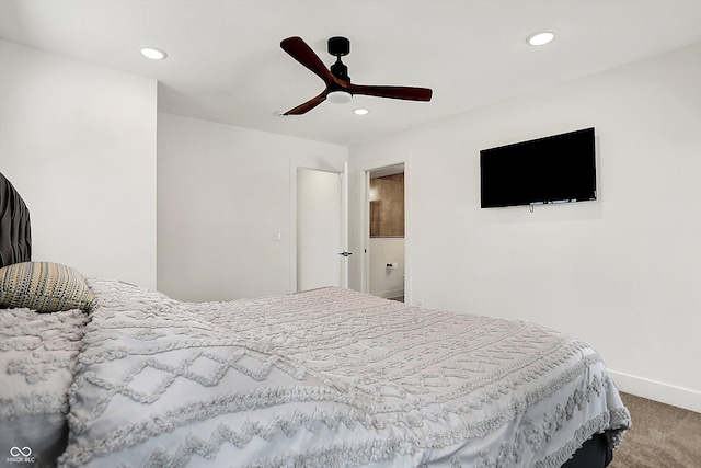 bedroom with ensuite bathroom, ceiling fan, and carpet flooring