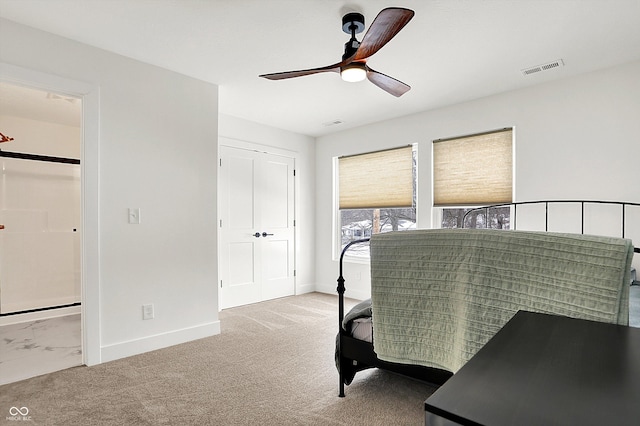 carpeted bedroom featuring a closet and ceiling fan