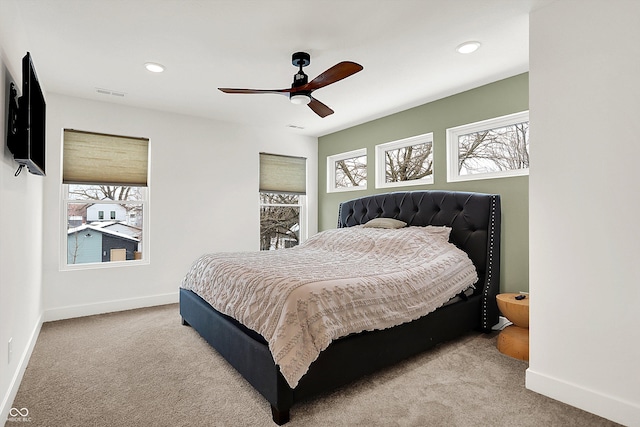 bedroom with ceiling fan and light colored carpet