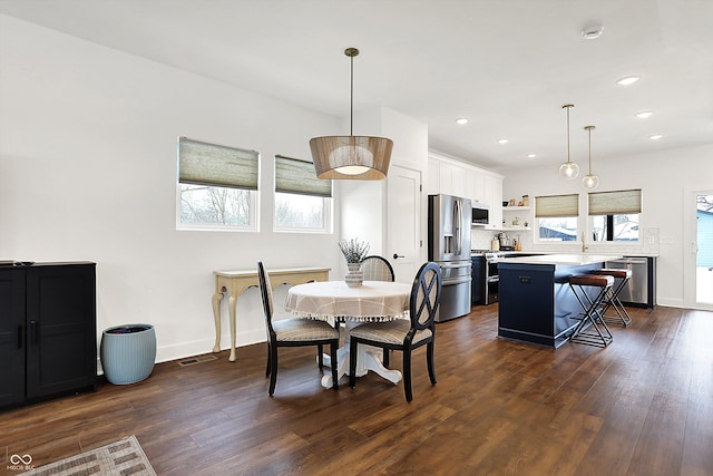 dining area featuring dark hardwood / wood-style floors