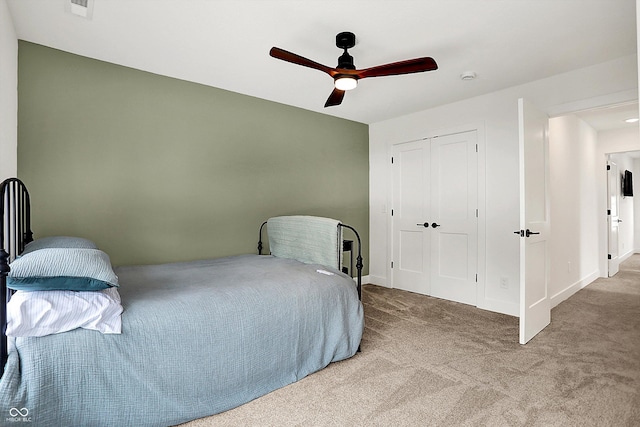 bedroom featuring ceiling fan, a closet, and carpet floors