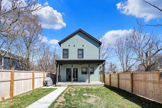 1656 Roosevelt Ave, Indianapolis, IN 46218 - rear view of property with a ceiling fan, a lawn, board and batten siding, and a fenced backyard
