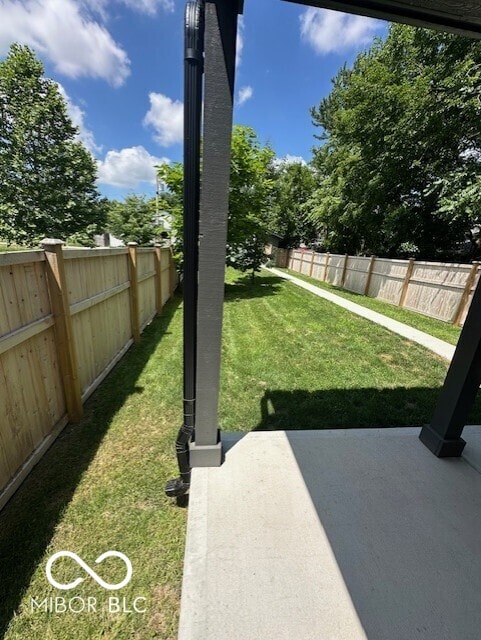 1656 Roosevelt Ave, Indianapolis, IN 46218 - fenced backyard featuring a patio area