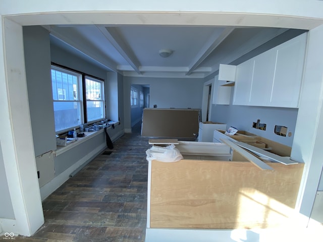 kitchen with coffered ceiling, white cabinetry, and beam ceiling