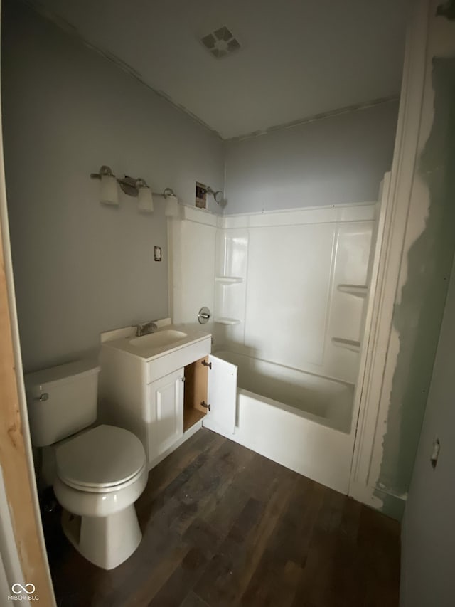 full bathroom with toilet, shower / washtub combination, wood-type flooring, and vanity