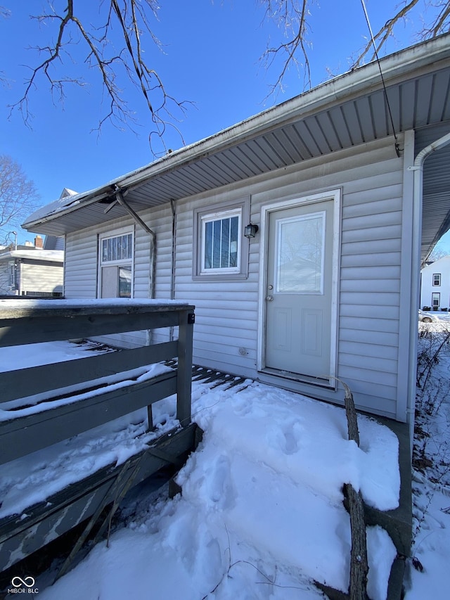 view of snow covered property entrance