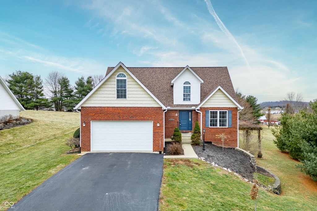 view of front facade with a garage and a front lawn