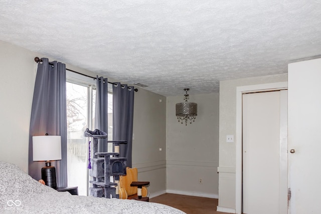 bedroom with a textured ceiling and a closet