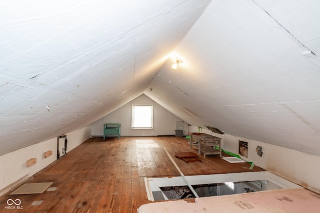 bonus room featuring lofted ceiling and hardwood / wood-style floors