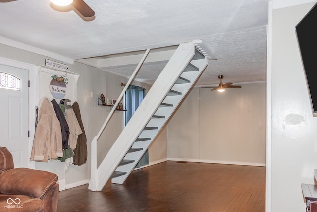 interior space with ceiling fan, crown molding, a textured ceiling, and hardwood / wood-style flooring