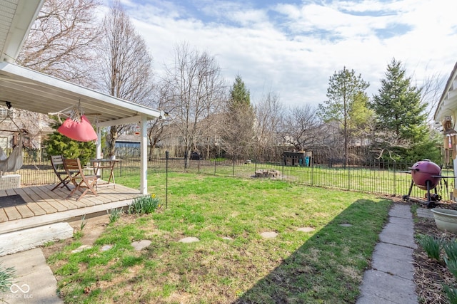 view of yard with a wooden deck and fence