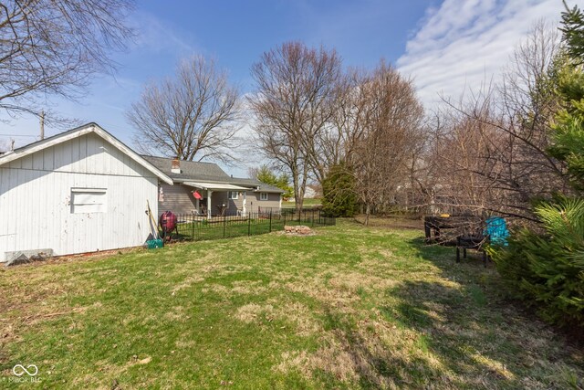 view of yard with a fire pit and fence
