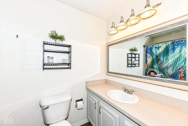 bathroom featuring toilet and vanity