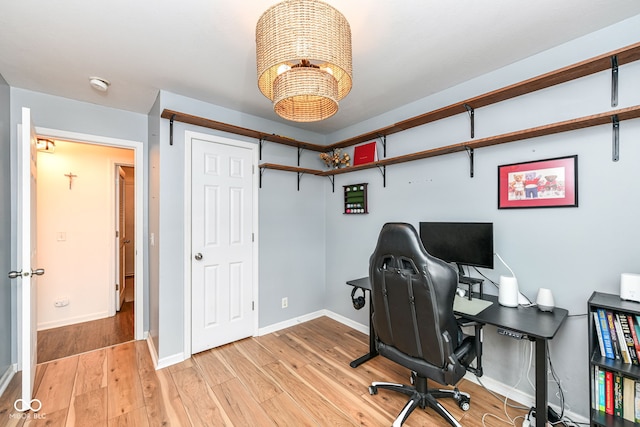 home office with light hardwood / wood-style floors