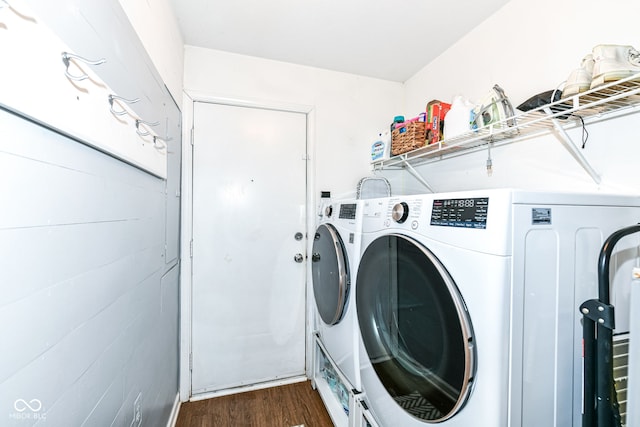 clothes washing area featuring washer and dryer and dark hardwood / wood-style flooring