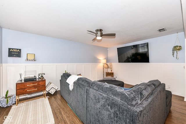 living room featuring ceiling fan and dark hardwood / wood-style flooring