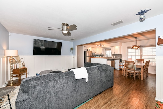 living room featuring hardwood / wood-style flooring and ceiling fan