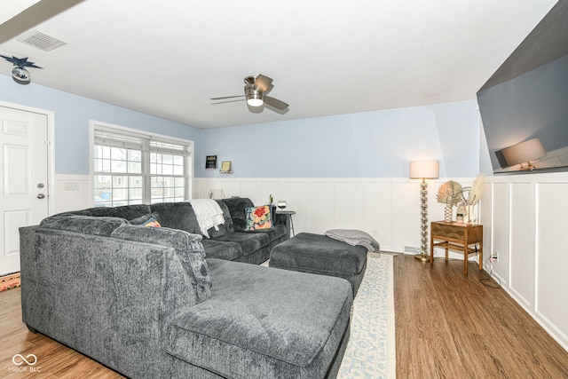 living room with ceiling fan and wood-type flooring