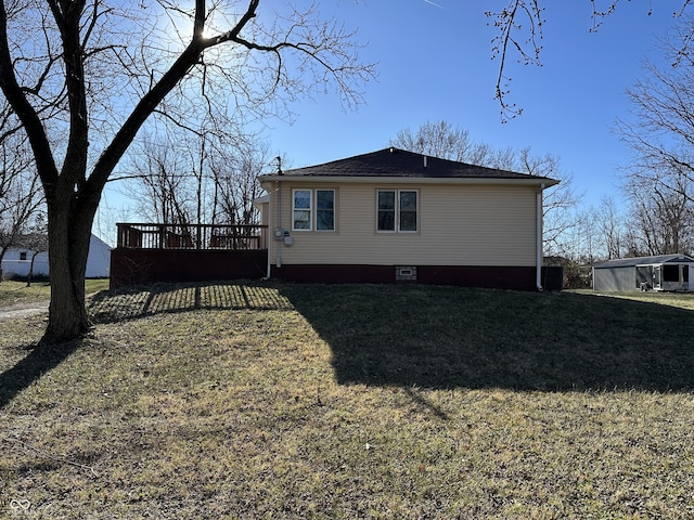 view of home's exterior featuring a yard and a wooden deck