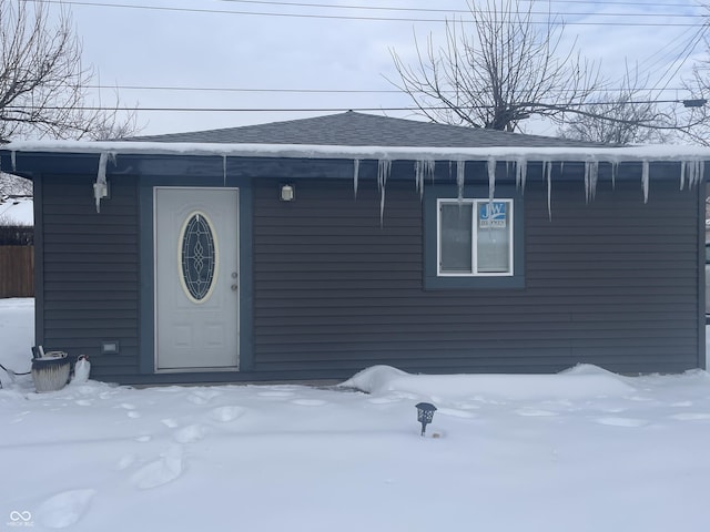 view of snow covered property entrance