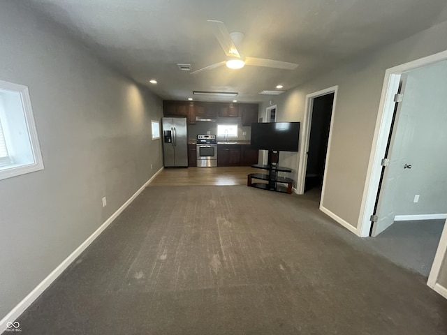 interior space featuring a wealth of natural light, ceiling fan, sink, and appliances with stainless steel finishes