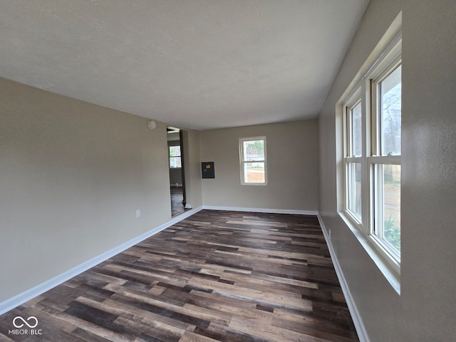 empty room featuring dark hardwood / wood-style flooring