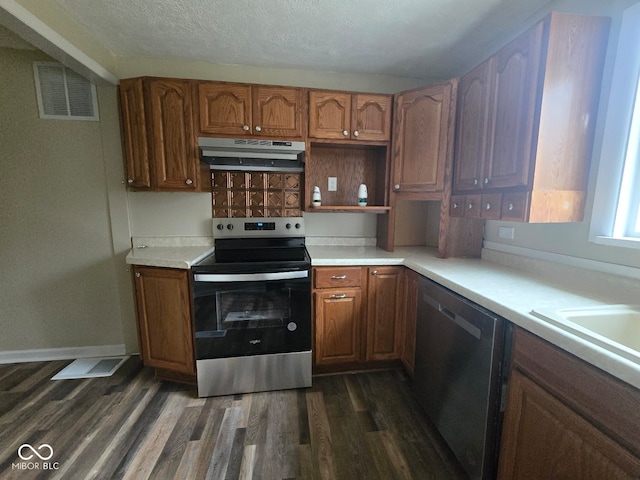 kitchen with a textured ceiling, dark hardwood / wood-style floors, decorative backsplash, and stainless steel appliances