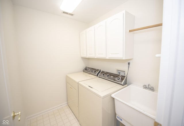 laundry room with sink, cabinets, and washing machine and clothes dryer