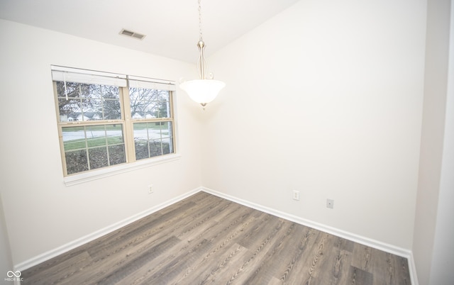 empty room featuring dark hardwood / wood-style flooring