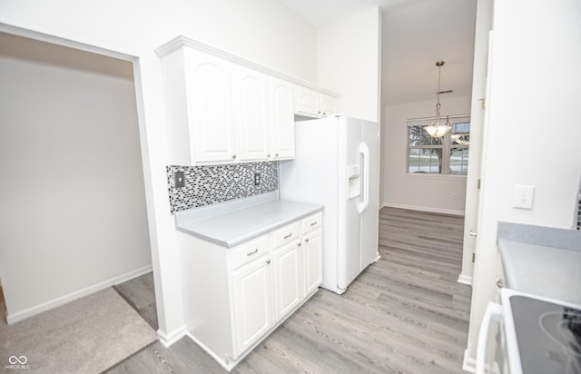 kitchen featuring light hardwood / wood-style flooring, pendant lighting, tasteful backsplash, white fridge with ice dispenser, and white cabinetry