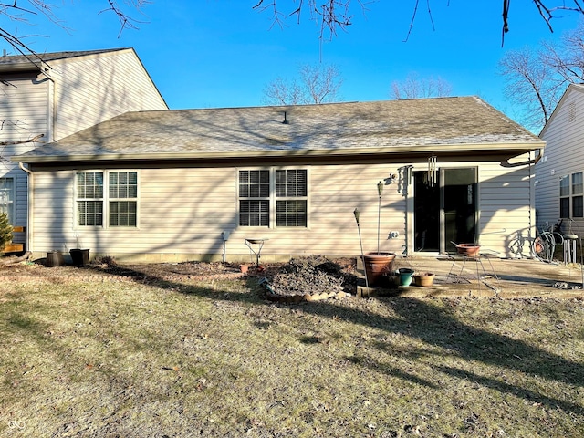 rear view of house with a yard and a patio