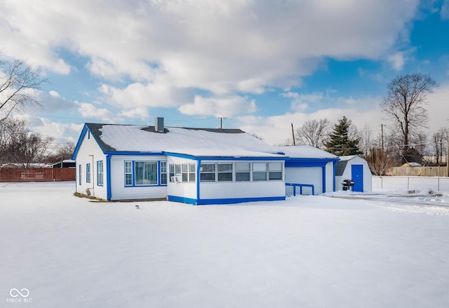 view of snow covered rear of property