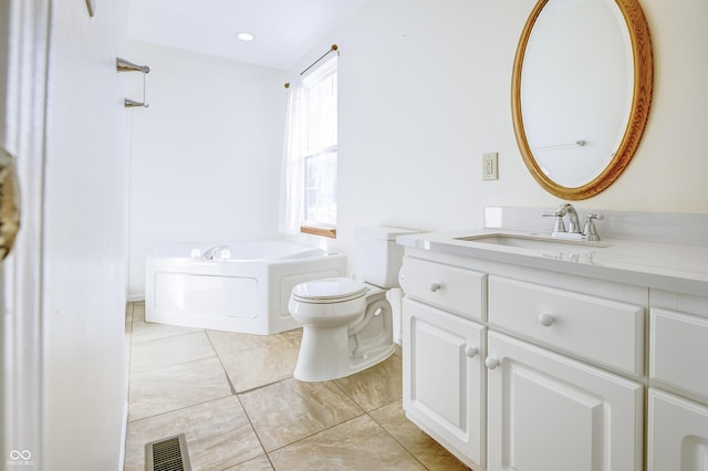 bathroom featuring toilet, a tub, tile patterned flooring, and vanity