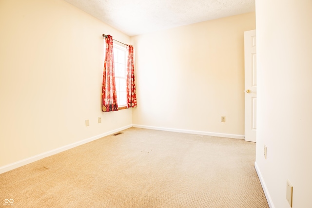 unfurnished room featuring carpet