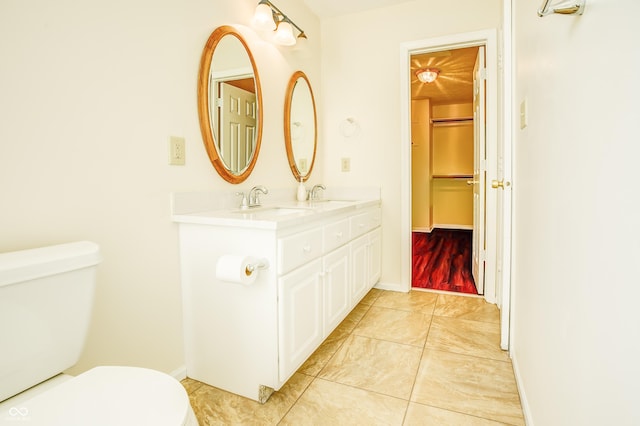 bathroom featuring toilet and vanity