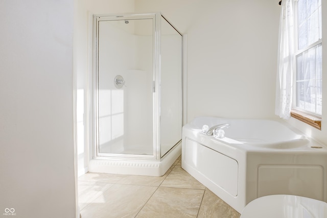 bathroom with shower with separate bathtub and tile patterned floors