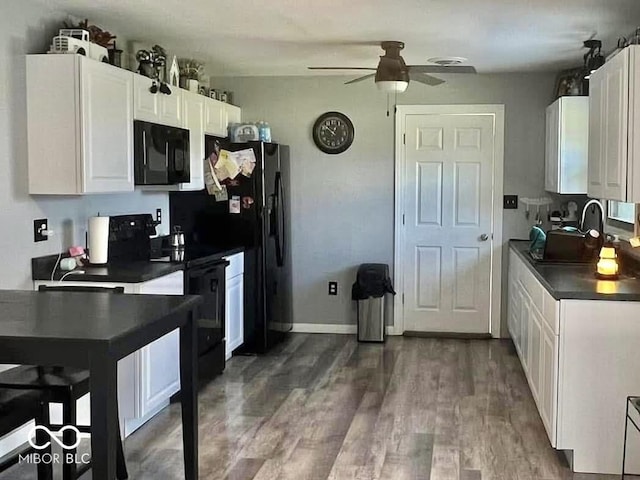 kitchen featuring black appliances, ceiling fan, dark hardwood / wood-style flooring, and white cabinetry