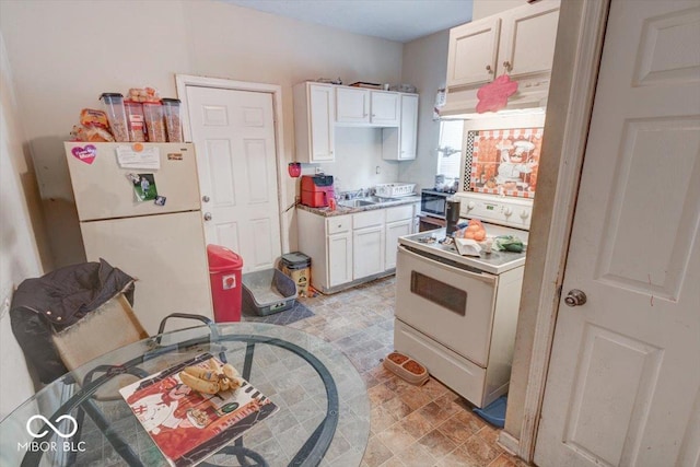 kitchen with white appliances and white cabinets