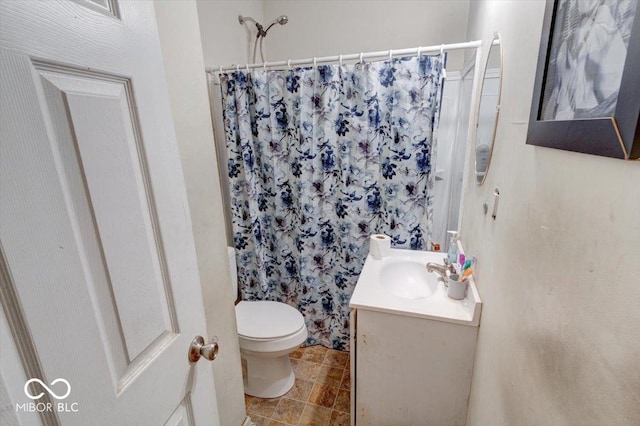 bathroom featuring vanity, toilet, and a shower with shower curtain