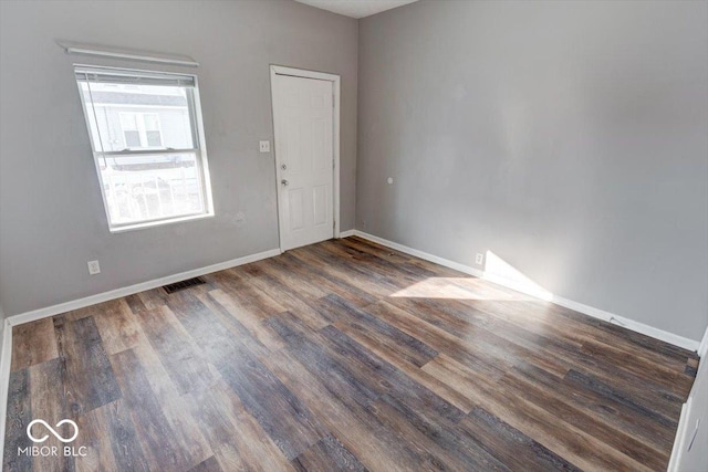 spare room with dark hardwood / wood-style floors