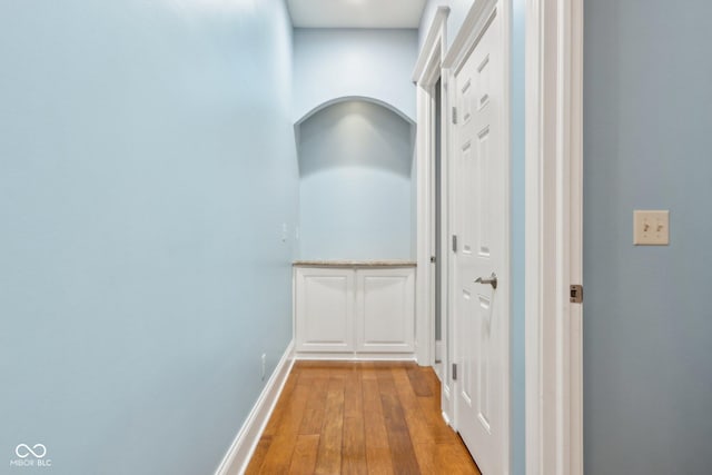 hallway with light hardwood / wood-style floors