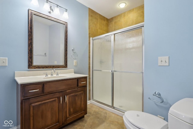 bathroom featuring vanity, an enclosed shower, and toilet