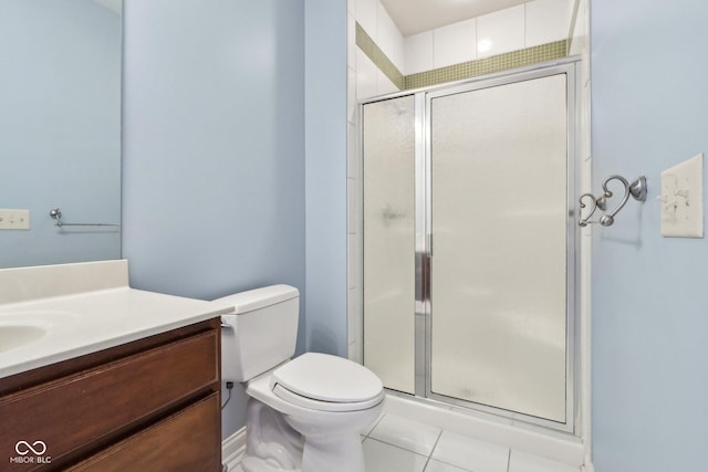 bathroom featuring vanity, tile patterned flooring, a shower with door, and toilet